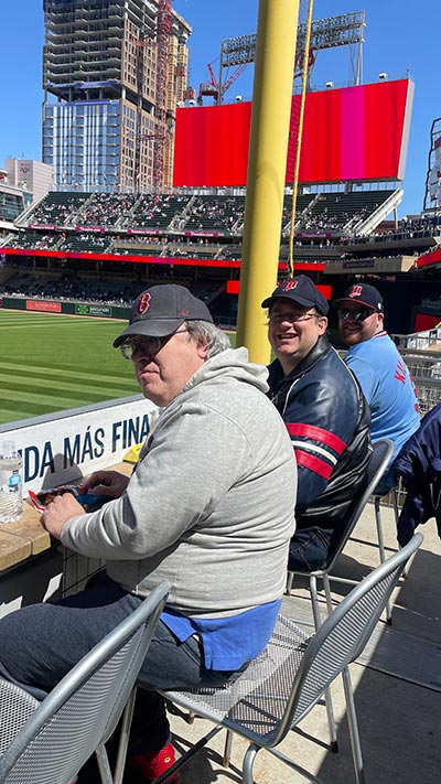 Enjoying a baseball game together during day services outing